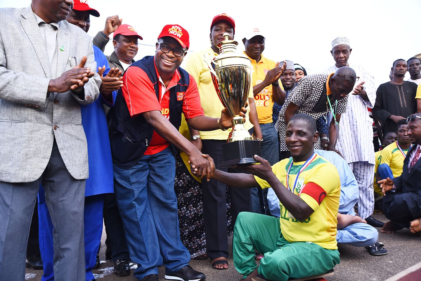Sir Emeka Offor presenting the trophy at the para-soccer final played by polio survivors to mark World Polio Day